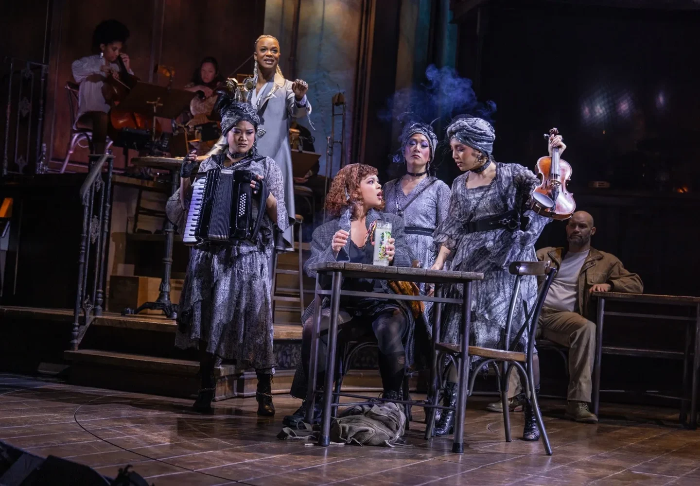 Hadestown cast gathered on the industrial-style stage